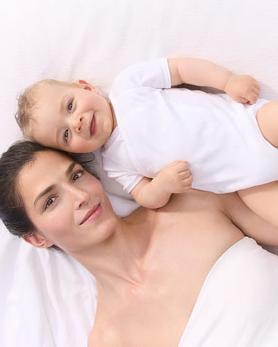 Mother and baby on bed