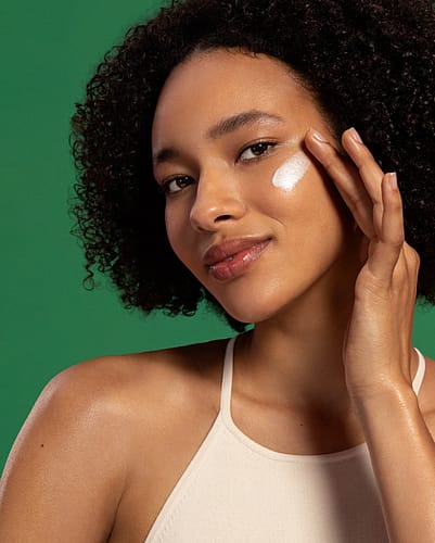 Woman with skin food glow drops on face
