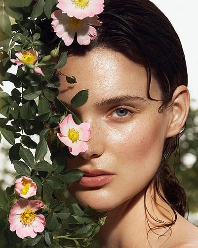 Womans face by rose bush