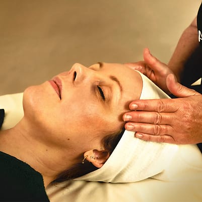 Woman giving a facial to another woman