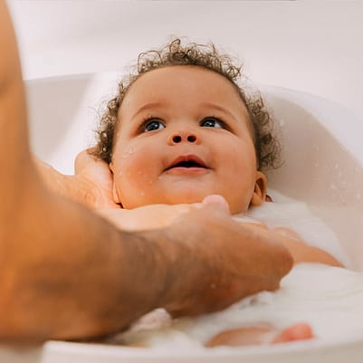 Dad washing baby