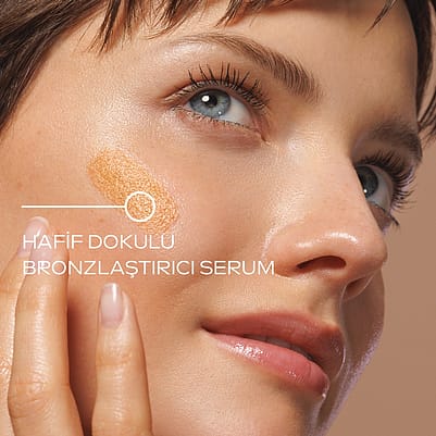 Model holds Product next to face
