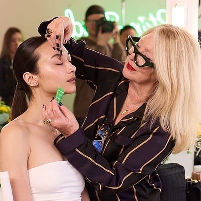 Val Garland applying Skin Food to a model