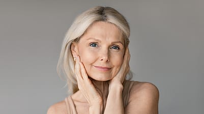 An older woman sitting relaxed in the park