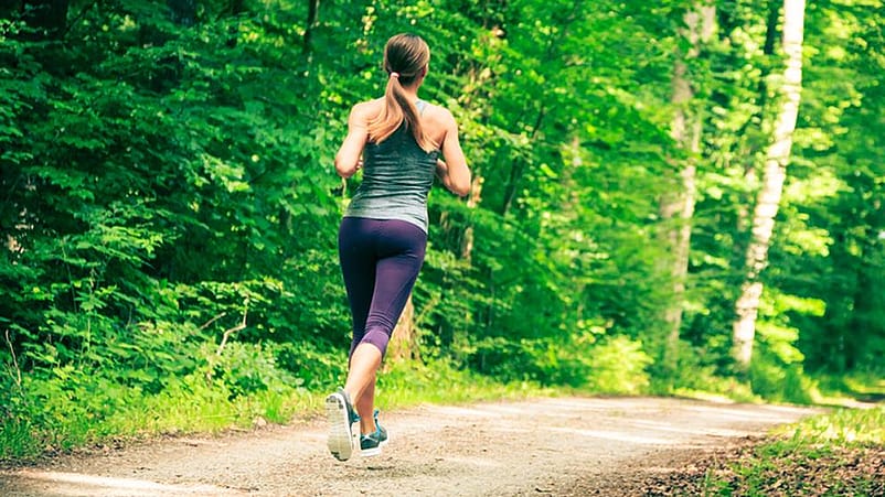 Frau joggt durch den Wald