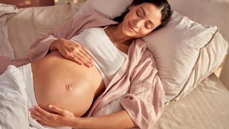 mujer embarazada tumbada en la cama