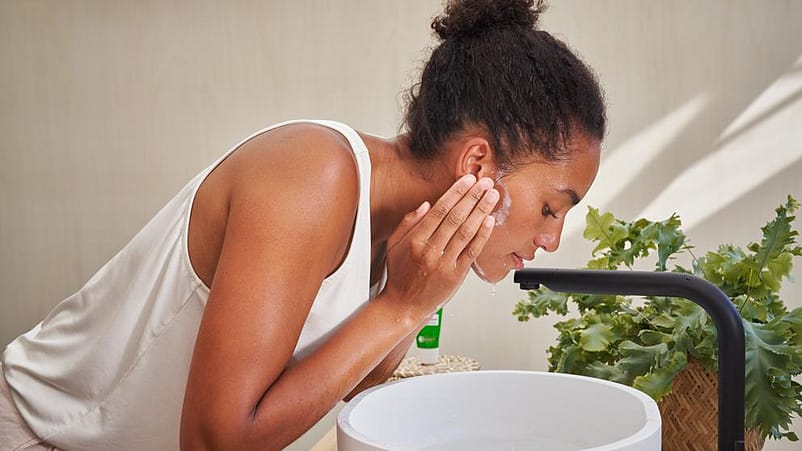 woman rinsing face