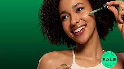 Smiling woman applying Skin Food Super Serum to her face with a dropper during EOFY sale.