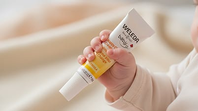 Baby hand holding Calendula Nappy Change Cream 10ml.