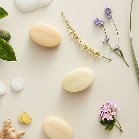 Weleda Soaps flat layed surrounded by flowers