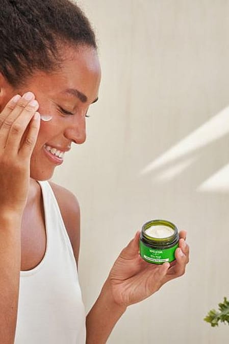 Woman applying skincare to her face