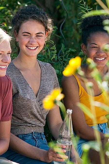 Three teen girls in a garden