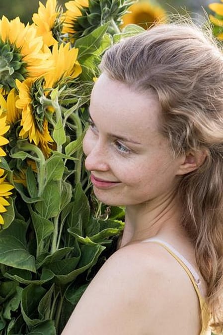woman holding sun flowers