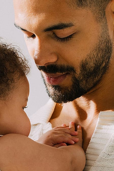 father holding babys head