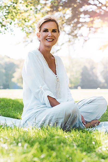 An older woman sitting relaxed in the park