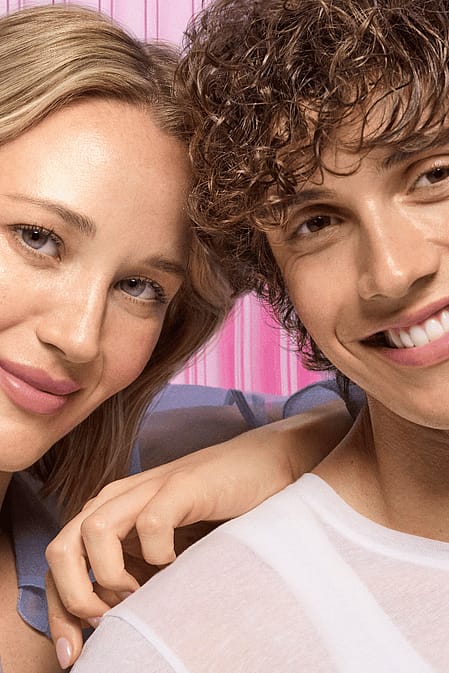 Two models looking into the camera with glowing skin