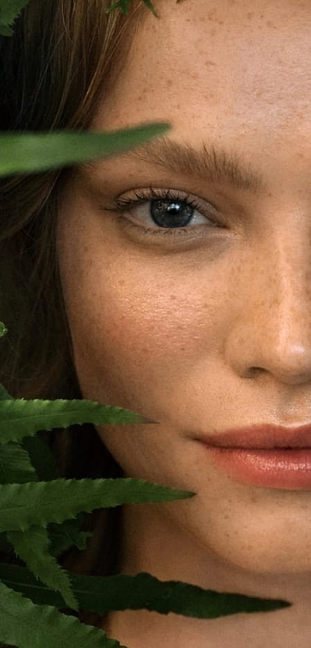 Womans face amongst leaves