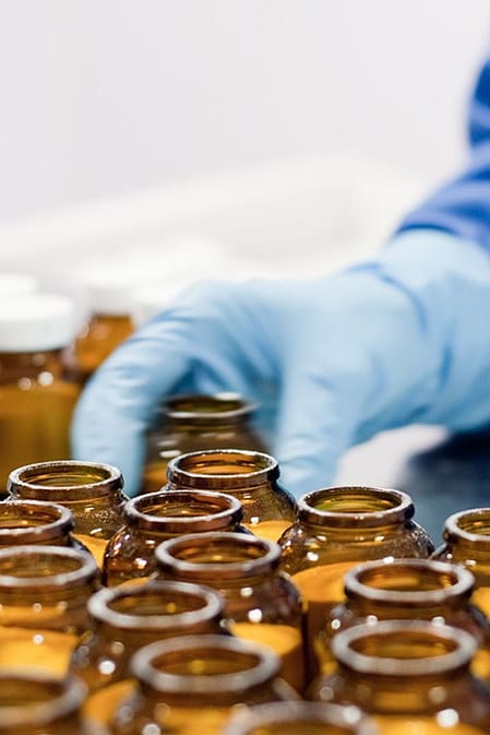 Technician with glass bottles