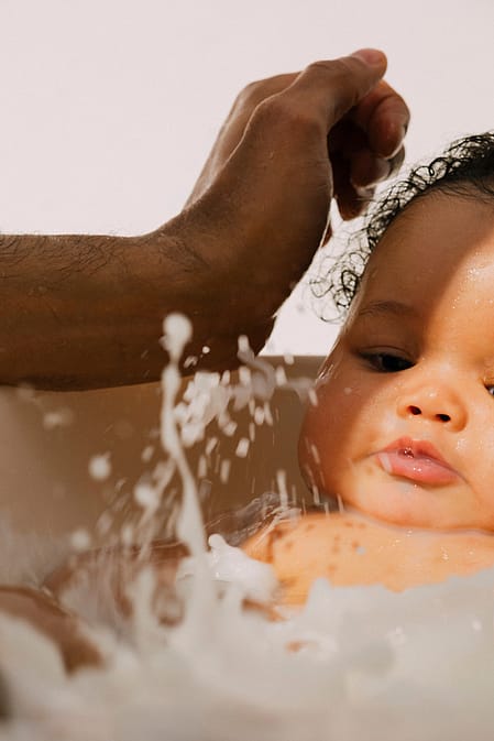 Dad washing baby in the bath