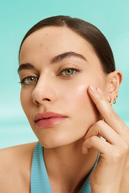 Model looking at her clear skin
