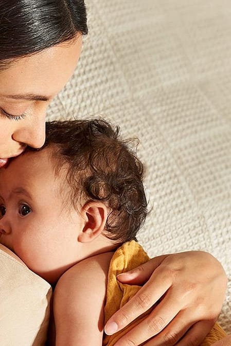 mother kissing baby