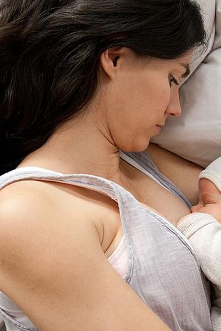 Mother laying down with baby