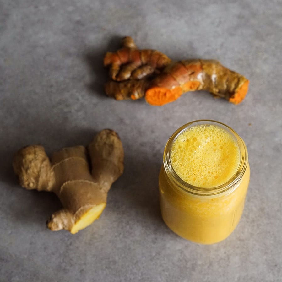 Ingwer Shot im Glas mit frischem Ingwer