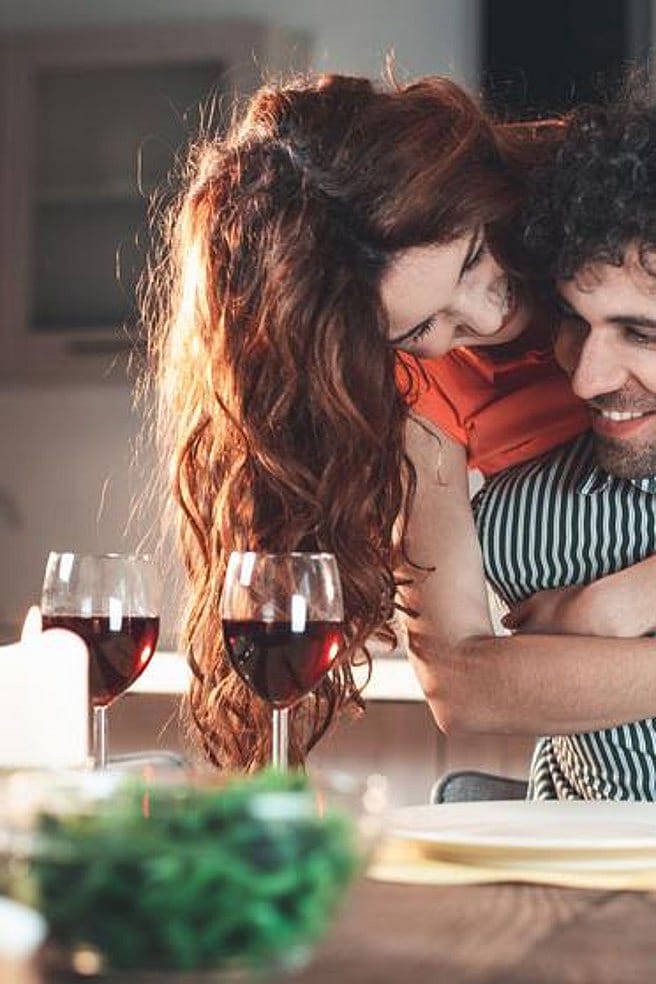 pareja abrazada durante una cena