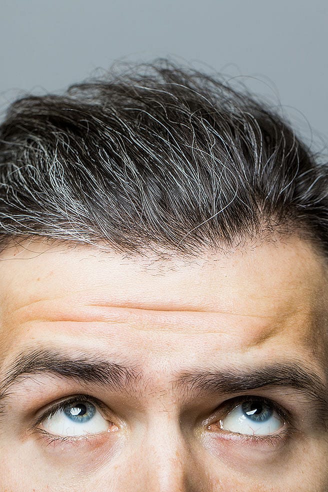 Gesicht eines Mannes mit grauen Haaren