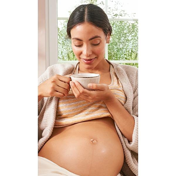 Pregnant woman drinking nursing tea.