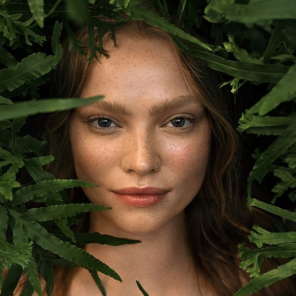 Closeup young woman surrounded by plants