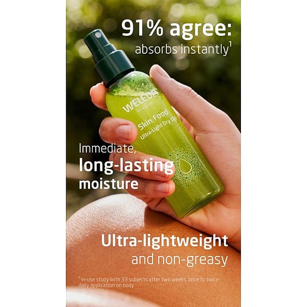 Woman's hand holding Skin Food Ultra-Light Dry Oil bottle surrounded by benefits text.