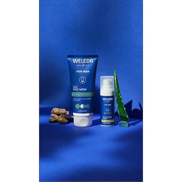 Men 5in1 Serum and Men 2in1 Face Wash on blue background surrounded by key ingredients willow back and aloe vera.
