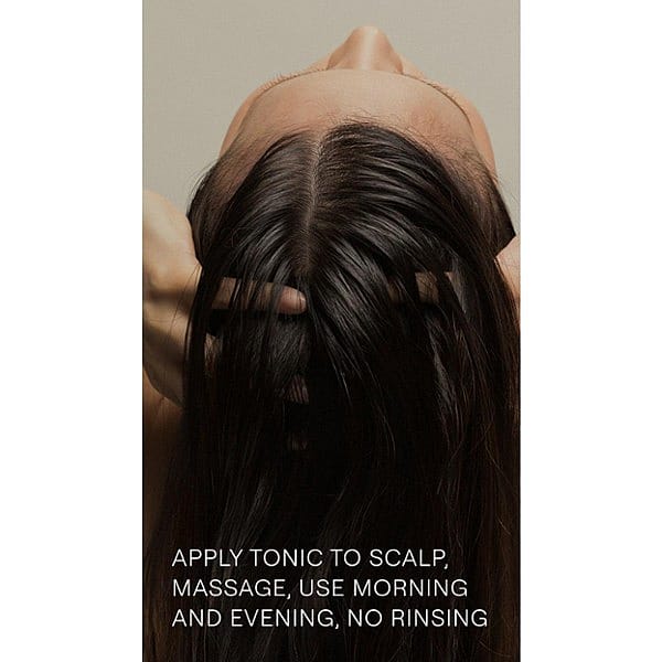 The back of a woman's head showing her long dark hair and Revitalising Hair Tonic how to use text.