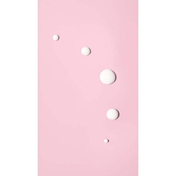 Smoothing Eye Cream Wild Rose & White Tea droplets on a pink background.
