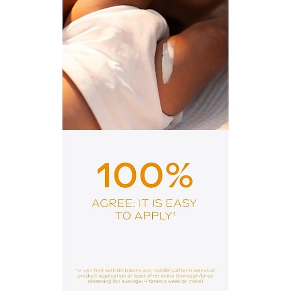 Dark skin baby in a white nappy with Calendula nappy change cream fragrance free swatch on his leg.