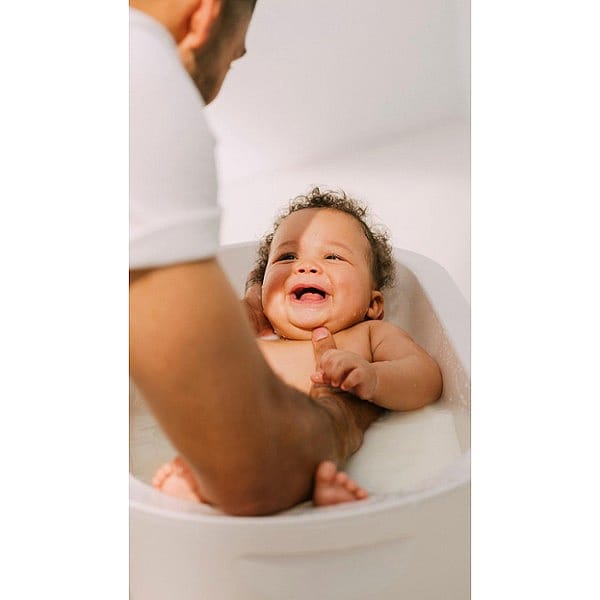 father bathing baby