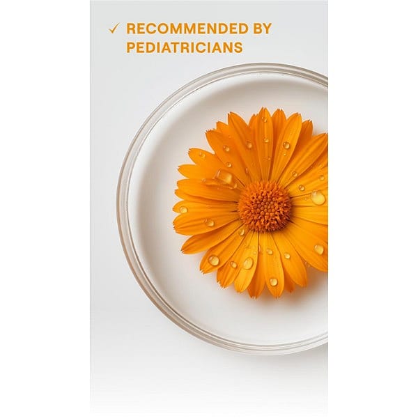 Calendula blossom in liquid in petri jar with text.