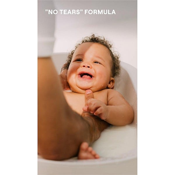 baby bathing and smiling, hold in hands with text.