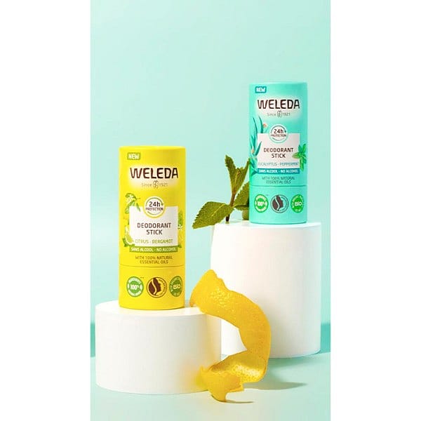 Deodorant stick Citrus-Bergamot and Eucalypptus-peppermint, placed on exaltations against turquoise background.