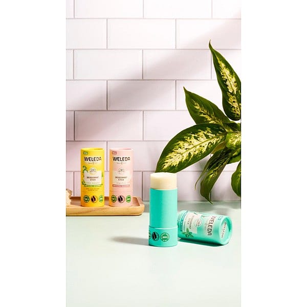 all three Deodorant sticks placed in bathroom against tiles.