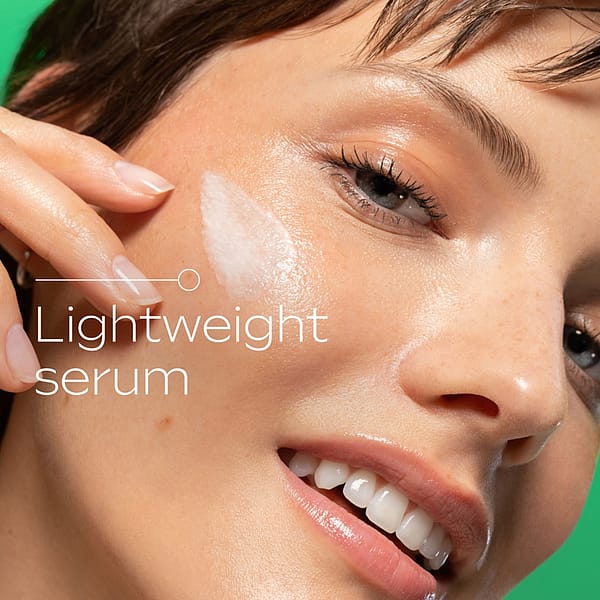 Close-up of a woman applying lightweight Slow-Ageing Astaxanthin Serum Booster Drops to her cheek, showing the serum’s smooth texture and radiant finish for youthful, glowing skin.