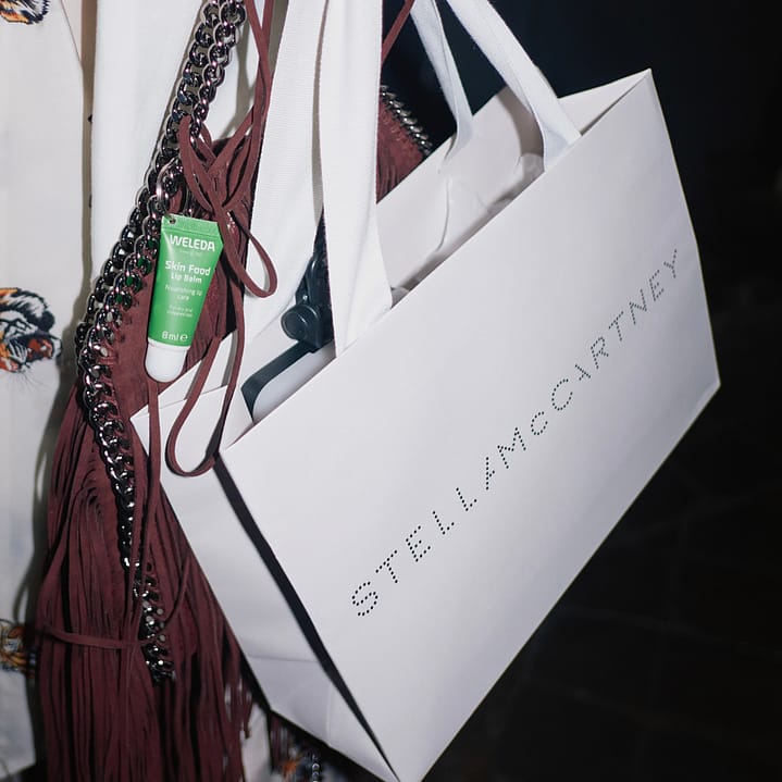 Stella McCartney shopping bag with attached Skin Food Lip Balm