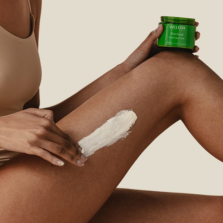 Model rubbing Skin Food Body Butter into her leg