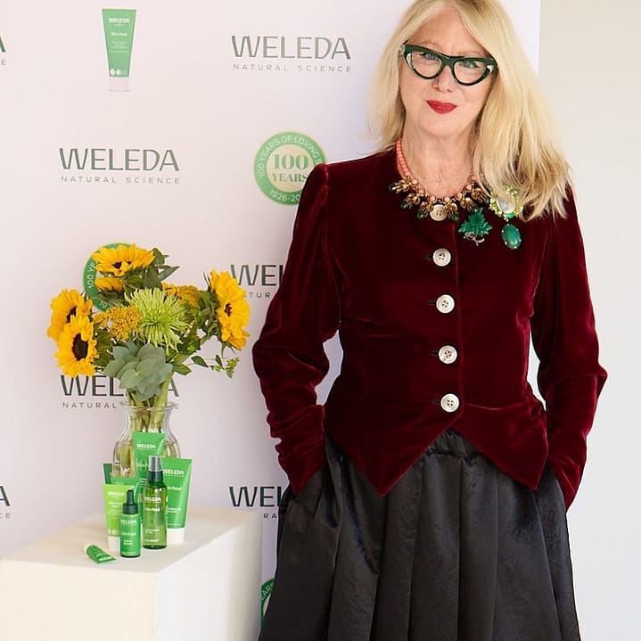 Val Garland standing in front of a Weleda branded backdrop